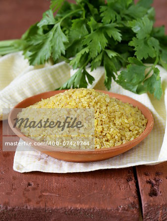 bulgur in a ceramic bowl on wooden table