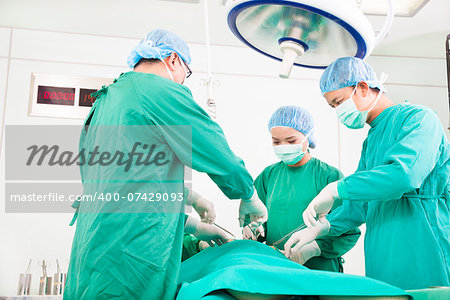 Team surgeon  working in operating room.