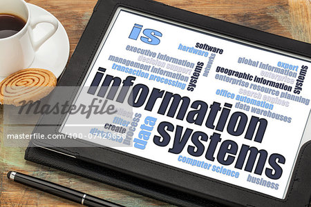 information systems word cloud on a digital tablet with a cup of coffee