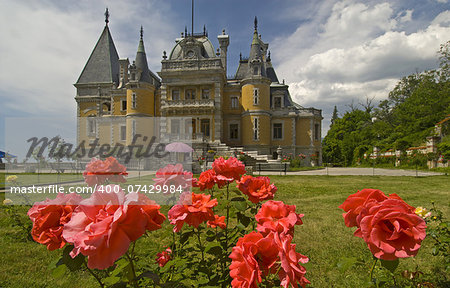 This is a view of Masandra Palace (Crimea). Beautiful roses are in the foreground.