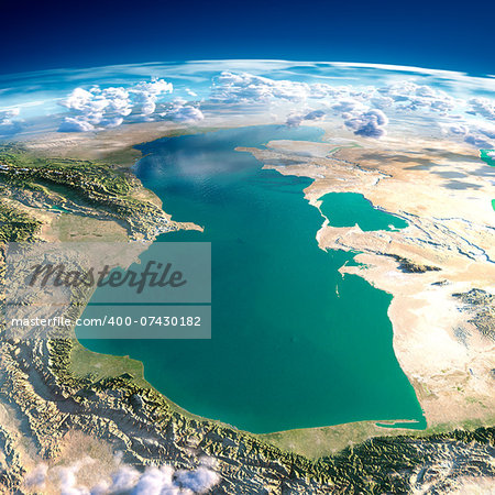 Highly detailed fragments of the planet Earth with exaggerated relief, translucent ocean and clouds, illuminated by the morning sun. Caspian Sea. Elements of this image furnished by NASA