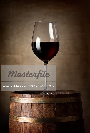 Red wine and barrel on a background of a canvas
