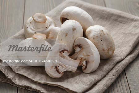 fresh white champignon on wood table, rustic style photo