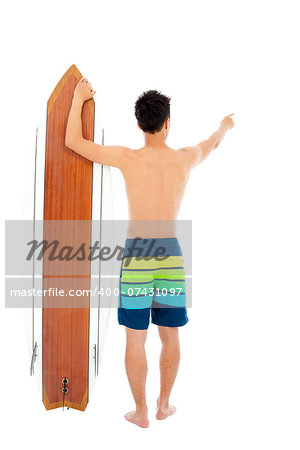 young guy standing and point forward with surfboard