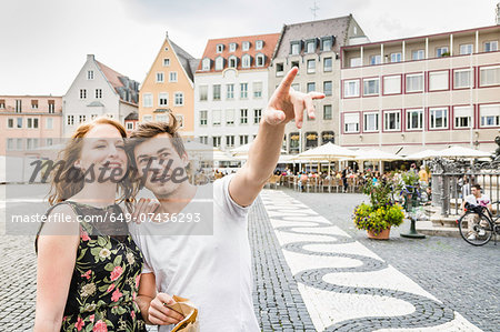 Young couple in town square in Augsburg, Bavaria, Germany