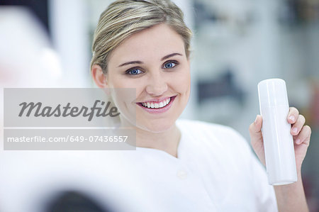 Shop assistant showing make up Shop assistant showing make up