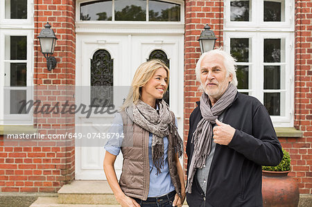 Father and daughter outside house