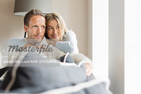 Portrait of mid adult couple looking away