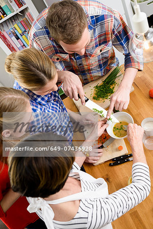 Mother, daughters and son preparing food, high angle