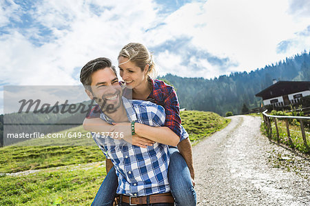 Woman riding piggyback on man, Tirol, Austria Woman riding piggyback on man, Tirol, Austria