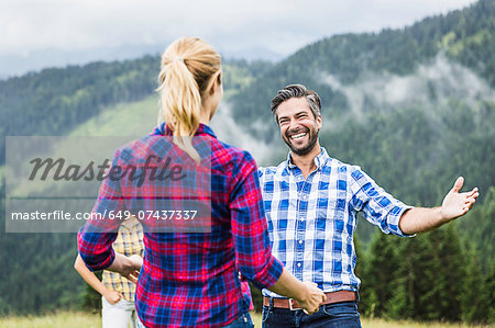 Man greeting woman with open arms, Tirol, Austria