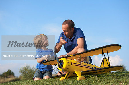 Father and son preparing model plane