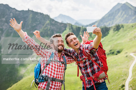 Two male friends photographing themselves, Tyrol, Austria