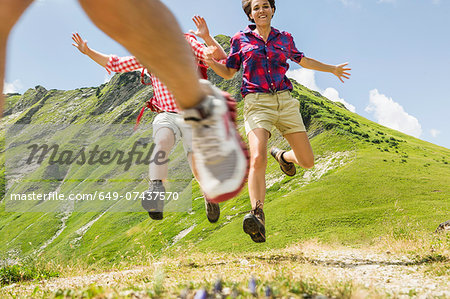 Group of friends jumping, Tyrol, Austria Group of friends jumping, Tyrol, Austria