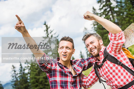 Two male friends pointing and cheering