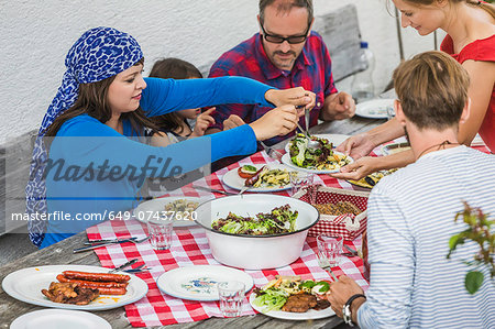 Family sitting down to picnic lunch, Tyrol, Austria