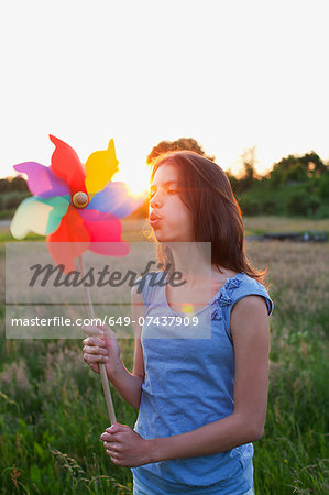 Girl blowing toy windmill