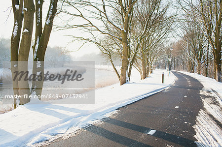 Rural road cleared of snow in winter