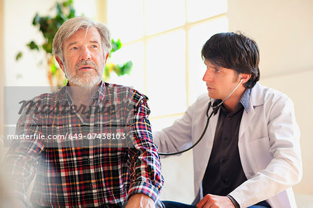 Doctor examining senior man