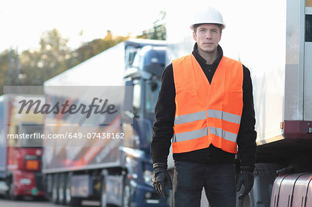 Builder standing in front of truck