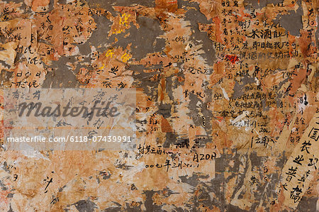 Layers of paper peeling off a wall, Kunming, China Layers of paper peeling off a wall, Kunming, China