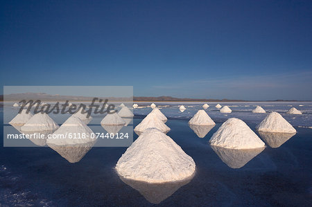 Piles of salt dry in the arid atmosphere of Bolivia's Salar de Uyuni.