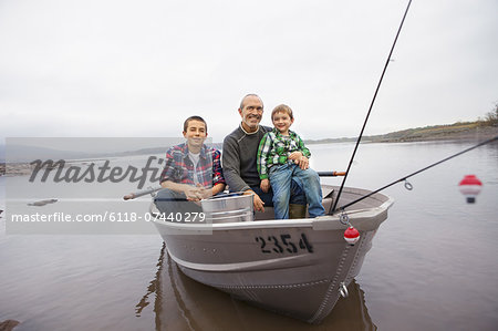 A day out at Ashokan lake. A man and two boys fishing from a boat.