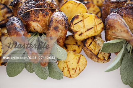 Organic free-range cooked chicken and roasted potatoes on a dish. Food for a party.