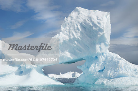 Icebergs floating on the Antarctic southern oceans. Eroded by wind and weather, creating natural ice arches.