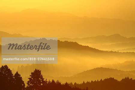 Clouds and Silhouetted Mountains in Morning Sunlight