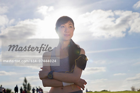 Portrait of young female runner with arms folded