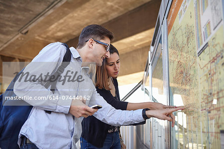 Couple looking at subway map, Los Angeles, California, USA