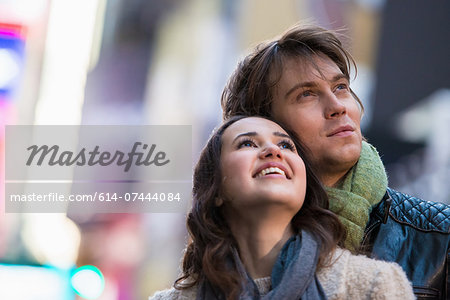 Young couple on vacation looking up, New York City, USA