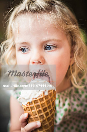 Little girl licking an ice cream