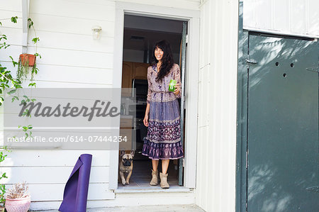 Young woman in doorway with vegetable juice