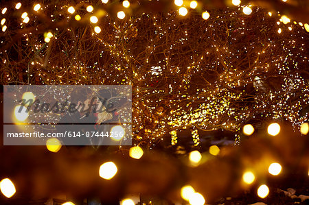 Young couple kissing surrounded by city xmas lights