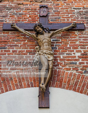 Crucifixion of Jesus Christ on red brick wall