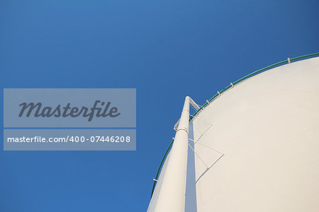 Oil storage tank and blue sky at refinery