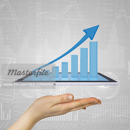 Hand holding a tablet pc. Growth chart on screen tablet