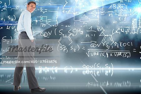 Happy businessman standing with hands in pockets against math equation background