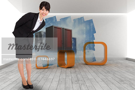 Smiling businesswoman bending against abstract screen in room showing server towers