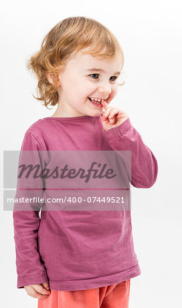 abashed caucasian girl looking to side. vertical image in light grey background