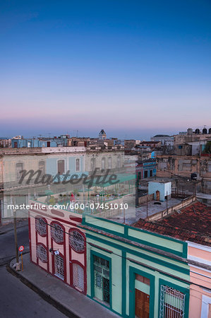 Overview of rooftops of buildings at dusk, Cienfuegos, Cuba, West Indies, Caribbean