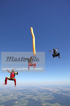 Three persons skydiving, Leutkirch im Allgaeu, Baden-Wuerttemberg, Germany, Europe