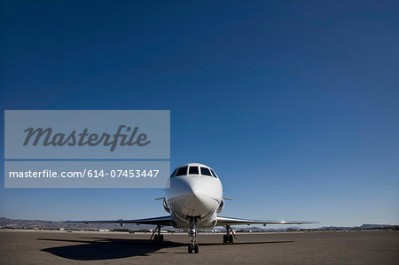 Stationary private jet on airfield tarmac