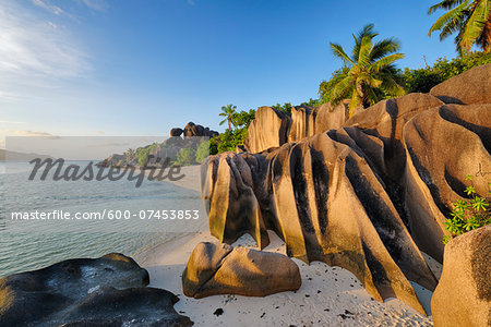 Rock Formations and Palm Trees near Sunset, Anse Source d´Argent, La Digue, Seychelles