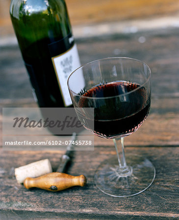 High angle view of red wine in glass and corkscrew High angle view of red wine in glass and corkscrew