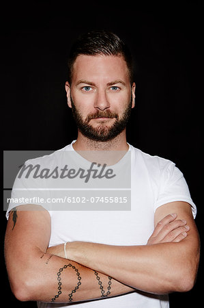 Portrait of mid adult man on black background