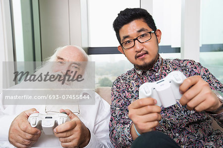 Portrait of grandson playing video game at home