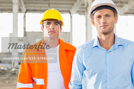 Portrait of confident male architects at construction site